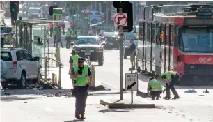  ?? AFP ?? Police and emergency personnel work at the scene of where a car ran over pedestrian­s in Flinders Street in Melbourne on Thursday. —