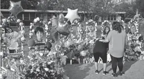  ?? JAE C. HONG/AP ?? Jolean Olvedo, left, weeps while being comforted by her partner, Natalia Gutierrez, on Tuesday at a memorial for Robb Elementary School students and teachers who were killed in last week’s school shooting in Uvalde, Texas.