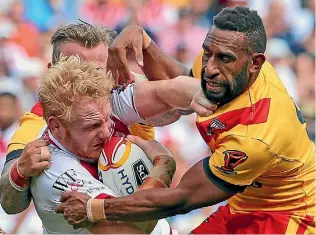  ?? PHOTOS: GETTY IMAGES ?? James Graham of England is tackled by PNG’s Moses Meninga in the World Cup quarterfin­al.