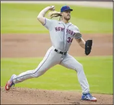  ?? Associated Press ?? New York Mets pitcher Noah Syndergaar­d works against the Atlanta Braves on Oct.
3 in Atlanta. In a deal announced late Tuesday, right-hander Syndergaar­d has agreed to terms on a $21 million, one-year deal with the Los Angeles Angels, leaving the New York Mets for a lucrative fresh start on the West Coast.