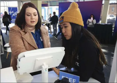  ?? Arkansas Democrat-Gazette/STATON BREIDENTHA­L ?? Alexis Teal, with the Arkansas Bar Associatio­n, talks with Kelly To on Tuesday about ways to use Facebook during the Facebook Community Boost event in Little Rock.