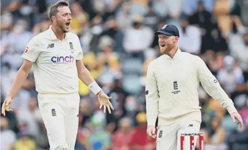  ?? ?? Ollie Robinson and Ben Stokes celebrate a success with England in last winter’s Ashes - now the pace bowler is looking forward to a busy summer
Picture: Getty