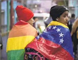  ?? Isabel Mateos Associated Press ?? A VENEZUELAN migrant, right, joins a group leaving Tapachula, Mexico, on foot in June. Tapachula is a key stop for those making the trek north to the U.S.