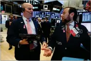  ?? AP PHOTO BY RICHARD DREW ?? Trader Patrick Casey, left, and specialist Michael Pistillo work on the floor of the New York Stock Exchange, Thursday, Nov. 29.