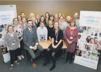  ??  ?? Martin Birch and Kathryn McCabe, front, pictured with members of the TfC fostering and adoption teams.