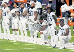  ?? AP ?? Members of the Tennessee Titans are seen prior to Sunday’s game against the Minnesota Vikings. The NFL says the Titans and Vikings are suspending in-person activities after the Titans had three players test positive for the coronaviru­s, along with five other personnel members.