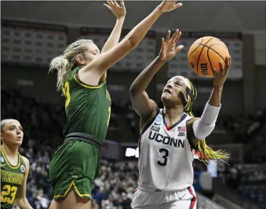  ?? AP PHOTO/JESSICA HILL ?? UConn’s Aaliyah Edwards (3) goes up for a basket as Vermont’s Delaney Richason (33) defends in the second half of a first-round college basketball game in the NCAA Tournament, Saturday, March 18, 2023, in Storrs, Conn.