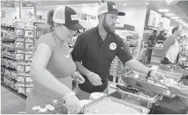  ?? PHILLIP VALYS/SOUTHFLORI­DA SUN SENTINEL 2017 ?? Workers hand out samples at the grand opening of Lucky’s Market’s Oakland Park location.