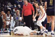  ?? Jessica Hill / Associated Press ?? UConn sophomore Paige Bueckers sustained a knee injury and had to be carried to the bench late in the Huskies’ victory over Notre Dame Sunday.