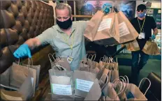  ?? Dan Watson/The Signal ?? Santa Clarita Grocery volunteers Dan Ziegler, left, and Bradley Grose pick up 35 pasta salad meals prepared for the Feed the Fight program by Newhall Refinery in Newhall on Thursday.