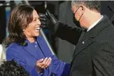  ?? Saul Loeb / Getty Images ?? Vice President Kamala Harris embraces her husband, Doug Emhoff, after she was sworn in.