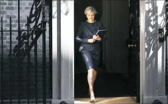  ?? Dan Kitwood/Getty Images ?? Prime Minister Theresa May prepares to make a statement to the nation in Downing Street, Tuesday, in London. The prime minister has called a general election for the United Kingdom to be held on June 8.