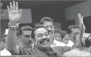  ??  ?? Sri Lanka’s former President Mahinda Rajapaksa waves at his supporters at the party office after a news conference. (Photo: Reuters)