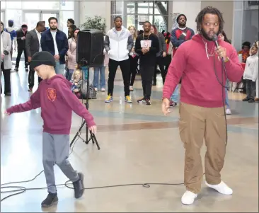  ?? ED BOOTH — ENTERPRISE-RECORD ?? Christen Brown, right, whose stage name is G'Riot, performs a rap with the theme of ending gun violence; his 9-year-old son, Eliyah, dances to the beat, at the Victory in Unity rally at Bell Memorial Union in Chico on Sunday.