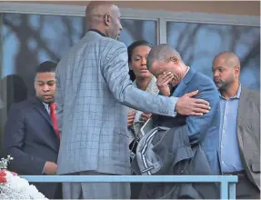  ?? JIM WEBER/THE (MEMPHIS) COMMERCIAL APPEAL ?? Basketball analyst David Aldridge is comforted by James Worthy and Swin Cash as they walk the Lorraine Motel balcony at the National Civil Rights Museum on Sunday afternoon during a tour.