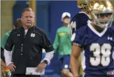  ??  ?? In this March 8 file photo, Notre Dame head coach Brian Kelly (left) runs drills during spring NCAA college football practice at the Loftus Sports Center in South Bend, Ind. AP PHOTO