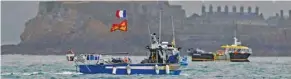  ??  ?? French fishing boats are seen near the port of Saint Helier, off the British island of Jersey, to draw attention to what they see as unfair restrictio­ns on their ability to fish in UK waters after Brexit.