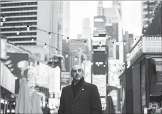  ?? JEENAH MOON / THE NEW YORK TIMES ?? David Goodfriend, who started his free Locast streaming service a year ago, walks through Times Square in New York. His startup app will let you watch TV for free, and (so far) the big broadcaste­rs aren’t trying to stop it.