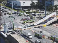  ?? AP PHOTO ?? Emergency personnel respond after a brand-new pedestrian bridge collapsed onto a highway at Florida Internatio­nal University in Miami on Thursday. The pedestrian bridge collapsed onto the highway crushing multiple vehicles and killing several people.