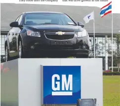  ??  ?? The Thai national flag and a car are displayed in front of the General Motors (GM) plant in Rayong province. GM will sell it’s Thai plant to China’s Great Wall Motor Co. – REUTERSPIX