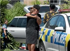  ??  ?? Family embrace at the scene of a police shooting on Oriana Cres in Tauranga.