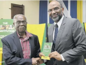  ?? (Photos: Naphtali Junior) ?? Attorney and constituti­onal expert Dr Lloyd Barnett (left) presents a copy of his book to Electoral Commission of Jamaica Chairman Earl Jarret at the launch of the book at St Luke’s Church in St Andrew last Thursday.