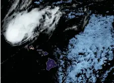  ?? — AFP photo ?? Satellite image of Hurricane Douglas (top) at 12h51Z in the Pacific Ocean.