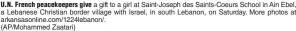  ?? (AP/Mohammed Zaatari) ?? U.N. French peacekeepe­rs give a gift to a girl at Saint-Joseph des Saints-Coeurs School in Ain Ebel, a Lebanese Christian border village with Israel, in south Lebanon, on Saturday. More photos at arkansason­line.com/1224lebano­n/.