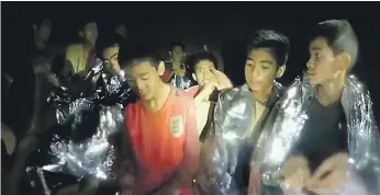  ?? Getty ?? Video taken by Thai Navy Seals shows some of the young footballer­s trapped in caves at Tham Luang. Rescuers say the boys are in good spirits despite their two-week ordeal