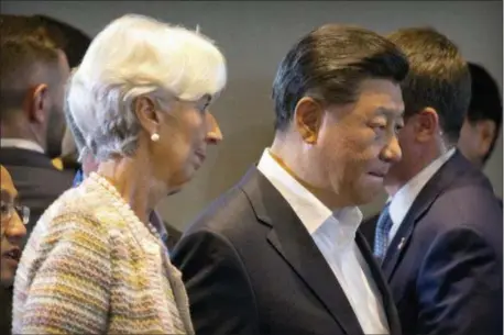  ?? MARK SCHIEFELBE­IN — THE ASSOCIATED PRESS ?? IMF managing director Christine Lagarde, left, and Chinese President Xi Jinping arrive for an Internatio­nal Monetary Fund (IMF) informal dialogue session at APEC Haus in Port Moresby, Papua New Guinea, Sunday.