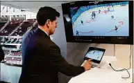  ?? Bill Kostroun / Associated Press ?? NHL senior director of coaching and general manager of technology Brant Berglund demonstrat­es the latest advances in puck and player tracking at a tech showcase before a game between the Sabres and Devils on April 21in Newark, N.J.