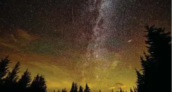  ?? Bill Ingalls / NASA via AP ?? In this 30-second cameras exposure, a meteor streaks across the sky during the annual Perseid meteor shower in Spruce Knob, W.Va.