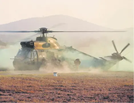  ?? Picture: Neil McCartney ?? Soldiers disembark an Oryx chopper after it did a hard landing during an air capability demonstrat­ion at Roodewal firing range in Polokwane, Limpopo, yesterday.