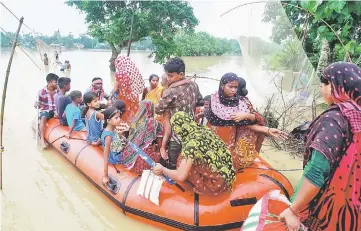  ??  ?? File photo shows flood-affected villagers being evacuated after heavy rain at Pratapgarh village on the outskirts of Agartala, India. — Reuters photo