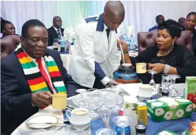  ??  ?? President Mnangagwa drinks maheu prepared by his wife, First Lady Auxillia Mnangagwa, while she also pours her share during an Angel of Hope Foundation “thank you” dinner for its partners at State House on Friday night. — Picture by John Manzongo