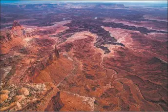  ??  ?? The Colorado River, the source of water for millions of Americans, meanders past Monster Tower in Utah.