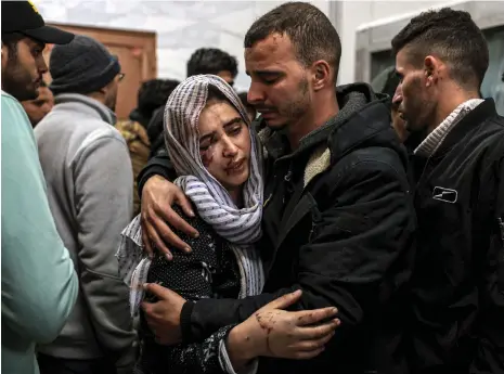  ?? AFP ?? Gazans gather at the EU Hospital in Khan Younis after an Israeli strike. The death toll in the enclave has passed 20,000