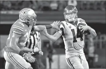  ?? Photograph­s by Wally Skalij Los Angeles Times ?? SAM DARNOLD, trying to get away from Ohio State’s Malik Harrison, figures to be a high draft choice if he decides to go pro. But he might decide to stay after a disappoint­ing finish in the Cotton Bowl.