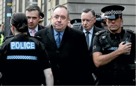  ?? AP ?? Former Scottish leader Alex Salmond, centre, leaves the Edinburgh Sheriff Court after his arrest, in Edinburgh. Salmond, one of the country’s bestknown politician­s, appeared in court on charges including attempted rape and sexual assault.