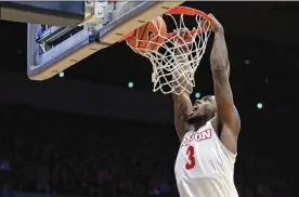  ?? DAVID JABLONSKI / STAFF ?? Dayton sophomore guard Trey Landers dunks Tuesday night against Davidson for two of his team-high 16 points in a 65-64 Flyers victory at UD Arena.