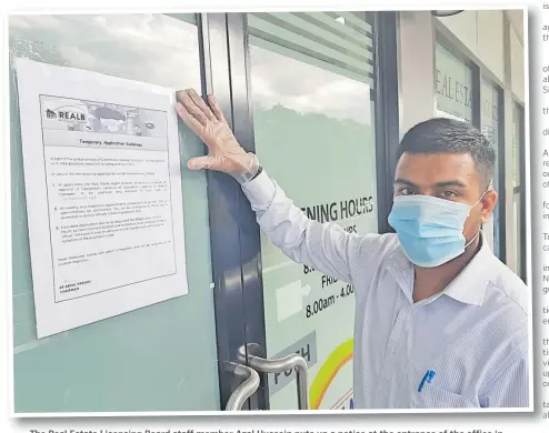  ?? Picture: SUPPLIED ?? The Real Estate Licensing Board staff member Azal Hussein puts up a notice at the entrance of the office in Flagstaff, Suva on last week.