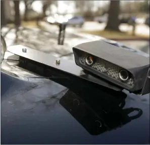  ?? AP PHOTO/DANNY JOHNSTON ?? In this Jan. 16, 2013, file photo, a camera is mounted near the rear window of a police car in Little Rock, Ark.