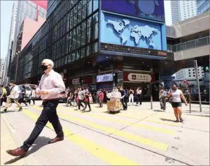  ?? CALVIN NG / CHINA DAILY ?? A street scene of the Central District of Hong Kong, China, on April 7. Experts believe Hong Kong has maintained its competitiv­eness on all fronts despite the challenges posed by the pandemic.