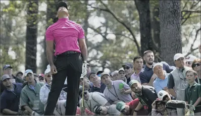  ?? PICTURE: AP PHOTO/ROBERT F BUKATY ?? UPS AND DOWNS:
Tiger Woods reacts to his tee shot on the fourth hole during yesterday’s first round.