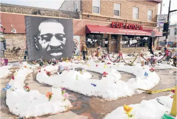  ?? JIM MONE/AP ?? George Floyd Square is shown Feb. 8 in Minneapoli­s. Ten months after Floyd’s death at the hands of police, the square remains a makeshift memorial. The trial of former police Officer Derek Chauvin is slated to begin with jury selection Monday.