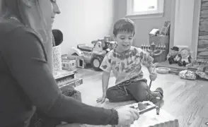  ?? EMMA H. TOBIN/AP ?? Ilana Diener plays with her son before a Moderna vaccine trial appointmen­t. Moderna said in March its vaccine works in the youngest kids.