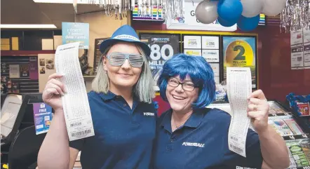  ?? Picture: Nev Madsen ?? BUSY TIME: Carlia Brackenbur­y (left) and Melanie King hope to sell the winning Powerball ticket.