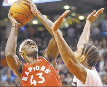  ?? Frank Gunn The Associated Press ?? Raptors forward Pascal Siakam eyes the basket against Nets forward Wilson Chandler in the fourth quarter of Toronto’s 119-118 win Saturday at Scotiabank Arena.