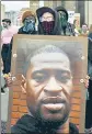  ?? REUTERS ?? ■
A protester holds a photo of George Floyd during a rally in Detroit, Michigan.