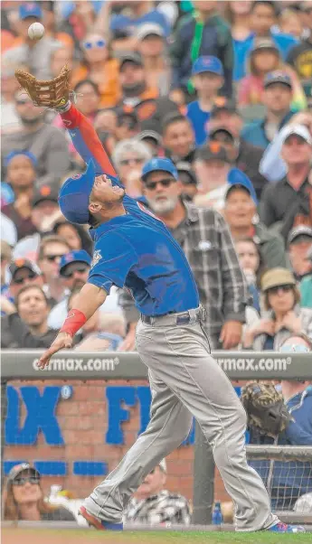  ??  ?? Willson Contreras, who played first base Wednesday, catches a pop- up against the Giants. | GETTY IMAGES